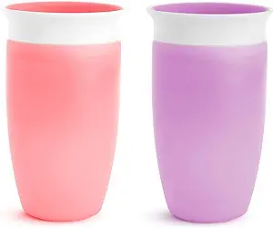 A pink cup and a purple cup, with white lids, and matching inserts on top of the lids to keep them from spilling.